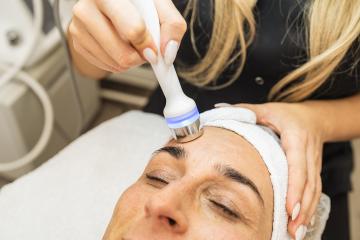 Professional female cosmetologist doing hydrafacial procedure in- Stock Photo or Stock Video of rcfotostock | RC Photo Stock