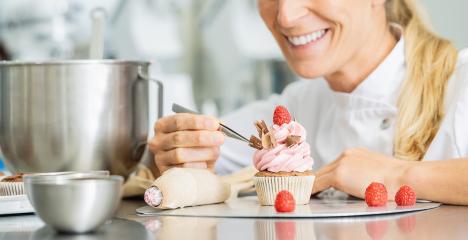 Professional women in pastry bakery as confectioner draped pieces of chocolate on a muffin topping with tweezers : Stock Photo or Stock Video Download rcfotostock photos, images and assets rcfotostock | RC Photo Stock.: