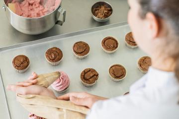 Professional women in pastry bakery as confectioner glazing muffins with icing bag : Stock Photo or Stock Video Download rcfotostock photos, images and assets rcfotostock | RC Photo Stock.: