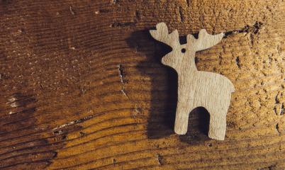 Raindeer ornament symbol on old wood background in greeting card style, including copy space- Stock Photo or Stock Video of rcfotostock | RC-Photo-Stock