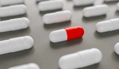 red and white pills or capsules lies in a two rows, Pharmacy theme- Stock Photo or Stock Video of rcfotostock | RC Photo Stock