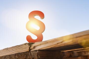 red paragraph sign with sun flare as a symbol for idea of law and justice- Stock Photo or Stock Video of rcfotostock | RC-Photo-Stock