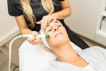 relaxed woman lying on the medical bed with her eyes closed while having aquafacial clean procedure at a cosmetology salon. : Stock Photo or Stock Video Download rcfotostock photos, images and assets rcfotostock | RC Photo Stock.: