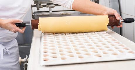 Rolling out cookie dough over a cookie cutter mold to shape cookies, using a wooden rolling pin, in a bakery setting : Stock Photo or Stock Video Download rcfotostock photos, images and assets rcfotostock | RC Photo Stock.: