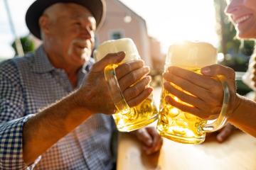 Senior man and woman in tracht toasting beer mugs in  traditional beer garden or oktoberfest at Bavaria, Germany, in summer- Stock Photo or Stock Video of rcfotostock | RC Photo Stock