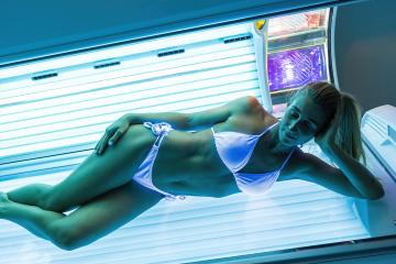 sexy woman in a bathing suit sunbathing in a solarium under the ultraviolet rays- Stock Photo or Stock Video of rcfotostock | RC Photo Stock
