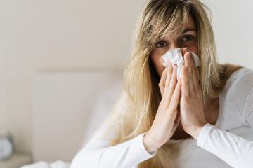 Sick woman suffering from running stuffy nose and sore throat. Upset ill european lady sits in bed, blowing her nose using paper napkin tissue. Cold And Flu Concept : Stock Photo or Stock Video Download rcfotostock photos, images and assets rcfotostock | RC-Photo-Stock.: