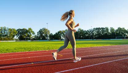 Side view of a woman running on a track in the sunlight : Stock Photo or Stock Video Download rcfotostock photos, images and assets rcfotostock | RC Photo Stock.: