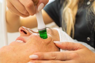 Side view of woman receiving aquafacial therapy on cheek at beauty spa : Stock Photo or Stock Video Download rcfotostock photos, images and assets rcfotostock | RC Photo Stock.: