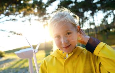 Smiling child holding wind turbine model at sunset at the forest smiling at camera. Energy Production with clean and Renewable Energy concept image : Stock Photo or Stock Video Download rcfotostock photos, images and assets rcfotostock | RC Photo Stock.: