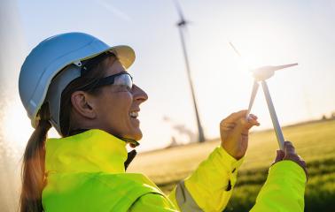 Smiling female engineer holding wind turbine model at sunset. New energy concept image- Stock Photo or Stock Video of rcfotostock | RC Photo Stock