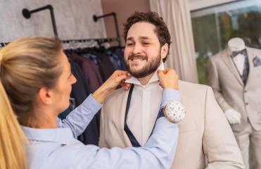 Tailor adjusting a man's collar in a suit shop, both are smiling- Stock Photo or Stock Video of rcfotostock | RC Photo Stock