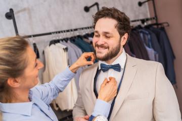 Tailor adjusting a tie for a happy client in a suit boutique- Stock Photo or Stock Video of rcfotostock | RC Photo Stock