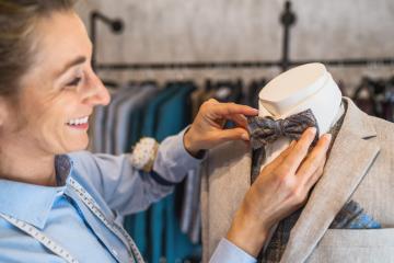 Tailor adjusting bow tie on mannequin in a boutique : Stock Photo or Stock Video Download rcfotostock photos, images and assets rcfotostock | RC Photo Stock.: