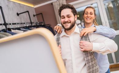 Tailor fitting a jacket on a happy male client, both smiling at a wedding store- Stock Photo or Stock Video of rcfotostock | RC Photo Stock