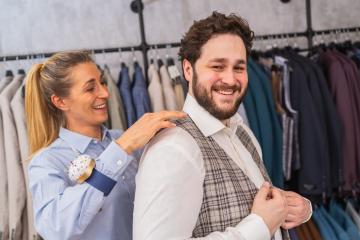 Tailor fitting a vest on a cheerful male client in a clothing store : Stock Photo or Stock Video Download rcfotostock photos, images and assets rcfotostock | RC Photo Stock.: