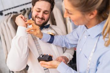 Tailor helping a man with cufflinks, both sharing a joyful moment
- Stock Photo or Stock Video of rcfotostock | RC Photo Stock