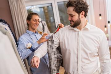 Tailor measuring a jacket on a client in a suit store- Stock Photo or Stock Video of rcfotostock | RC Photo Stock