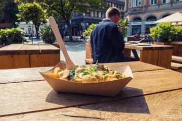 Tasty french fries with sauce in a cub at restaurant table in the city- Stock Photo or Stock Video of rcfotostock | RC Photo Stock