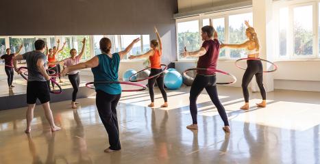 Team Sport Sporty women and men exercising with Hula hoop in fitness gym for healthy lifestyle concept.- Stock Photo or Stock Video of rcfotostock | RC Photo Stock