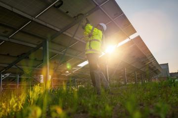 Technician assembling solar panels with a cordless drill at a solar field from behind. Alternative energy ecological concept image. : Stock Photo or Stock Video Download rcfotostock photos, images and assets rcfotostock | RC Photo Stock.: