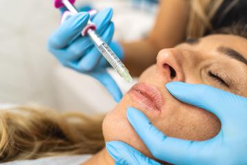 The doctor cosmetologist makes Lip augmentation procedure of a beautiful woman in a beauty salon. Cosmetology skin care. : Stock Photo or Stock Video Download rcfotostock photos, images and assets rcfotostock | RC Photo Stock.: