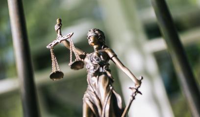 The Statue of Justice - lady justice or Iustitia / Justitia the Roman goddess of Justice against a prison grid, legal law concept image- Stock Photo or Stock Video of rcfotostock | RC-Photo-Stock