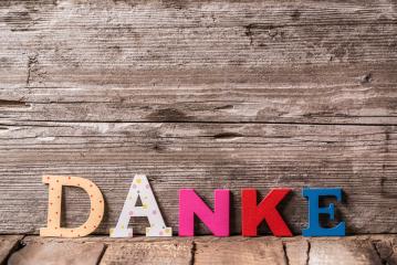 The word "DANKE" in colorful wooden letters placed on a rustic wooden surface, creating a simple and heartfelt expression of gratitude in a cozy and natural setting- Stock Photo or Stock Video of rcfotostock | RC Photo Stock