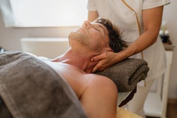 Therapist giving a neck massage to a male client in a bright spa room : Stock Photo or Stock Video Download rcfotostock photos, images and assets rcfotostock | RC Photo Stock.: