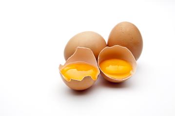 Three brown eggs are displayed on a white background, with two cracked open to reveal fresh, golden egg yolks inside their shells. : Stock Photo or Stock Video Download rcfotostock photos, images and assets rcfotostock | RC Photo Stock.: