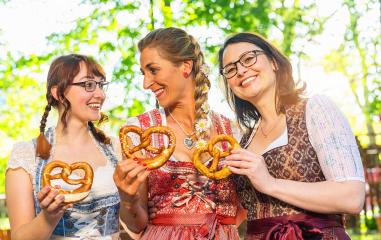 Three girl friends, having fun in beer garden holding  Traditional Bavaria pretzels, Germany- Stock Photo or Stock Video of rcfotostock | RC Photo Stock