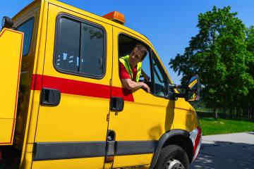 Tow truck driver sitting in a yellow truck looking out of the window and checks whether he can maneuver : Stock Photo or Stock Video Download rcfotostock photos, images and assets rcfotostock | RC Photo Stock.: