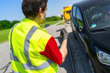 Tow truck operator uses a remote control to load an accident car onto the tow truck : Stock Photo or Stock Video Download rcfotostock photos, images and assets rcfotostock | RC Photo Stock.:
