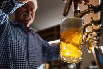 traditional bartender in tracht pouring draft beer at german Oktoberfest or Biergarden- Stock Photo or Stock Video of rcfotostock | RC Photo Stock