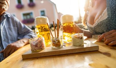 Traditional Bavarian Obatzda with pretzels and radishes and beer mugs, senior man and woman in the background at beer garden or oktoberfest, Munich, Germany : Stock Photo or Stock Video Download rcfotostock photos, images and assets rcfotostock | RC Photo Stock.: