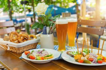Traditional beer garden food with obatzter beer mugs with fresh pretzels or brezen and bread at Oktoberfest, Munich, Germany- Stock Photo or Stock Video of rcfotostock | RC Photo Stock