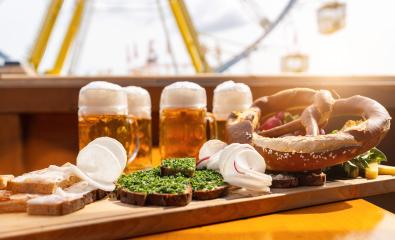 Traditional German food and beer mugs on a wooden tray with ferris wheel ride in the background at oktoberfest or  dult in germany : Stock Photo or Stock Video Download rcfotostock photos, images and assets rcfotostock | RC Photo Stock.: