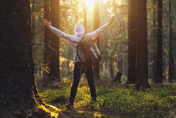 Traveler Man raised hands at sunset in the forest - Travel Lifestyle emotional concept- Stock Photo or Stock Video of rcfotostock | RC-Photo-Stock