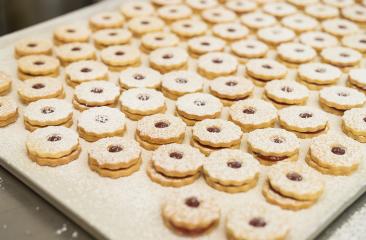 tray filled with Linzer cookies dusted with powdered sugar. Each cookie has a jam-filled center and a scalloped edge, creating a festive and delicious display : Stock Photo or Stock Video Download rcfotostock photos, images and assets rcfotostock | RC Photo Stock.: