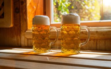 Two beer mugs with frothy beer rest on a ledge, catching sunlight. spa and wellness concept image- Stock Photo or Stock Video of rcfotostock | RC Photo Stock