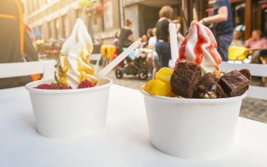 two frozen yoghurt cups with brownie and fruits toppings on a restaurant table- Stock Photo or Stock Video of rcfotostock | RC Photo Stock