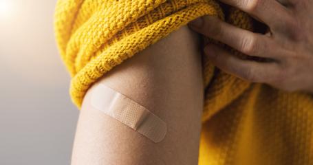 vaccine for corona COVID-19 and SARS cov. Woman holding up her sweater sleeve and showing her arm with Adhesive bandage Plaster after receiving vaccination injection, banner size- Stock Photo or Stock Video of rcfotostock | RC-Photo-Stock