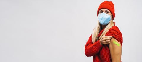 vaccine injection for corona virus COVID-19. Woman with face mask holding up her sweater sleeve and showing her arm with green Adhesive bandage Plaster after receiving vaccination, copy space banner- Stock Photo or Stock Video of rcfotostock | RC Photo Stock