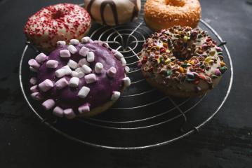 various baked donuts on a bakery grid, sweet food- Stock Photo or Stock Video of rcfotostock | RC Photo Stock