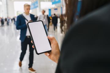 view of a smartphone in female hands with empty screen, with crowd of people, copyspace for your individual text.- Stock Photo or Stock Video of rcfotostock | RC Photo Stock