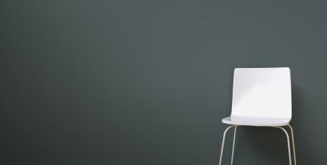 white chair in a waiting room in front of a grey wall, with copy space for individual text - Stock Photo or Stock Video of rcfotostock | RC-Photo-Stock