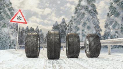 Winter tires on a snowy roadway with road sign- Stock Photo or Stock Video of rcfotostock | RC Photo Stock
