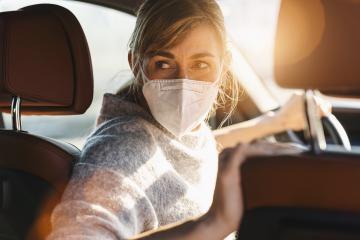 Woman driving car with a N95 FFP2 anti virus mask, protective mask against coronavirus, driver on a city street looking back, check behind going reverse during a coronavirus outbreak, covid-19.- Stock Photo or Stock Video of rcfotostock | RC-Photo-Stock