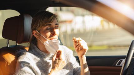 Woman driving car with a N95 FFP2 anti virus mask, removing protective mask against coronavirus, on a city street face mask off, to take a deep breath during a coronavirus outbreak, covid-19.- Stock Photo or Stock Video of rcfotostock | RC Photo Stock