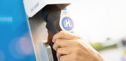 Woman hold a fuel dispenser with hydrogen logo on gas station. h2 combustion engine for emission free eco friendly transport concept image- Stock Photo or Stock Video of rcfotostock | RC Photo Stock
